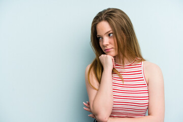 Young caucasian woman isolated on blue background who feels sad and pensive, looking at copy space.