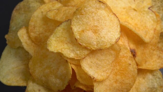 Craft crispy potato chips rotating close up. Golden