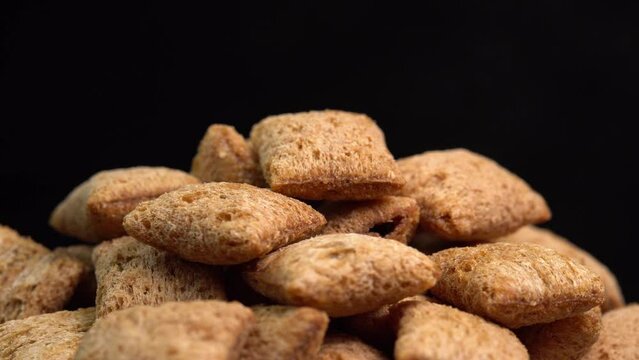 Crispy chocolate pads rotation in macro on black background.