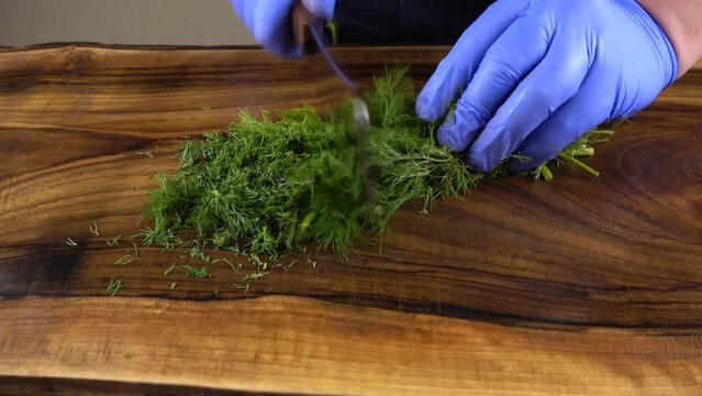 The cook cuts fennel on a board.