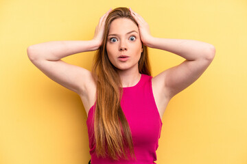 Fototapeta premium Young caucasian woman isolated on yellow background being shocked, she has remembered important meeting.
