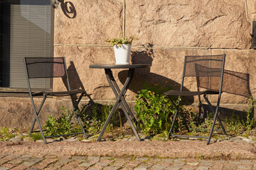 Table and chairs outside the cafe.