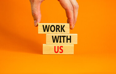 Work with us symbol. Concept words Work with us on wooden blocks on a beautiful orange table orange background. Businessman hand. Business, motivational and work with us concept. Copy space.