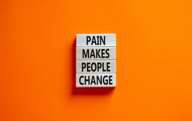 Pain makes people change symbol. Concept words Pain makes people change on wooden blocks on a beautiful orange table orange background. Business, motivational and pain makes people change concept.