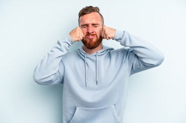 Fototapeta premium Young caucasian man isolated on blue background whining and crying disconsolately.