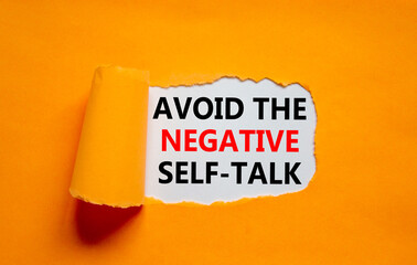 Avoid negative self-talk symbol. Concept words Avoid the negative self-talk on white paper on a beautiful orange background. Psychological and Avoid negative self-talk concept. Copy space.