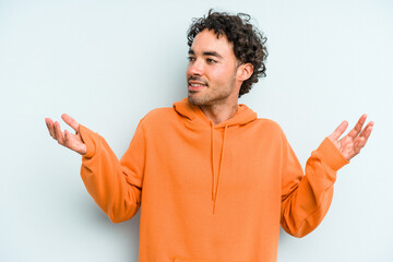 Young caucasian man isolated on blue background joyful laughing a lot. Happiness concept.