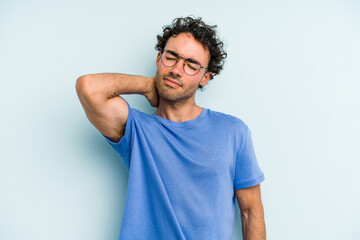 Fototapeta premium Young caucasian man isolated on blue background massaging elbow, suffering after a bad movement.