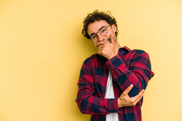 Young caucasian man isolated on yellow background laughing happy, carefree, natural emotion.