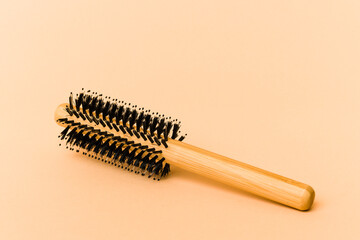 Hairbrush isolated on beige background
