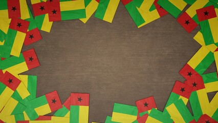 Frame made of paper flags of Guinea-Bissau arranged on wooden table. National celebration concept. 3D illustration