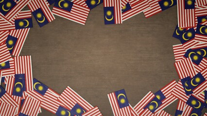 Frame made of paper flags of Malaysia arranged on wooden table. National celebration concept. 3D illustration