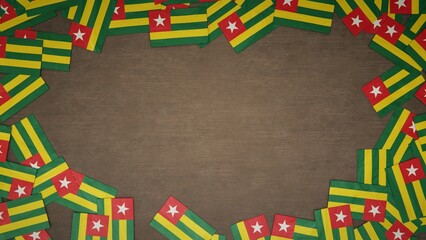 Frame made of paper flags of Togo arranged on wooden table. National celebration concept. 3D illustration