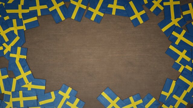 Frame made of paper flags of Sweden arranged on wooden table. National celebration concept. 3D illustration