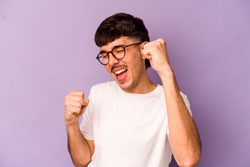 Fototapeta premium Young caucasian man isolated on purple background dancing and having fun.