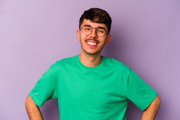 Obraz premium Young caucasian man isolated on purple background happy, smiling and cheerful.