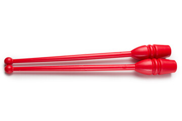 two red clubs for gymnastics, lie side by side, on a white background