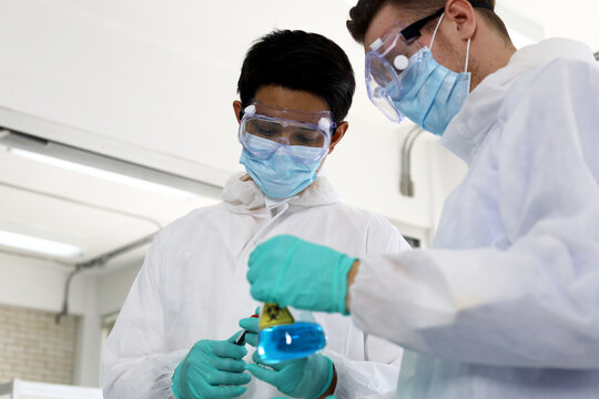 Closeup young men scientist testing and checking in lab room.