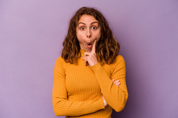 Fototapeta premium Young caucasian woman isolated on purple background having some great idea, concept of creativity.