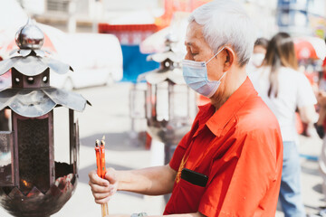 Portrait image adult 60 years old. Elderly man wearing mask to protect against toxic dust pm2.5 or...