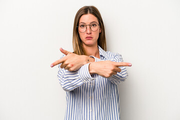 Young caucasian pregnant woman isolated on white background points sideways, is trying to choose between two options.