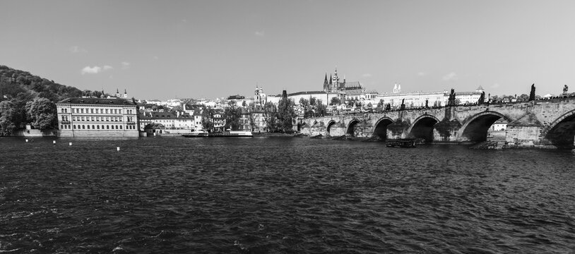 Panoramic black and white photo of Prague with Charles Bridge