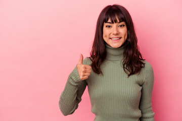 Young caucasian woman isolated on pink background smiling and raising thumb up