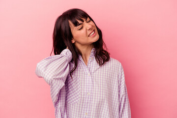Fototapeta premium Young caucasian woman isolated on pink background having a neck pain due to stress, massaging and touching it with hand.