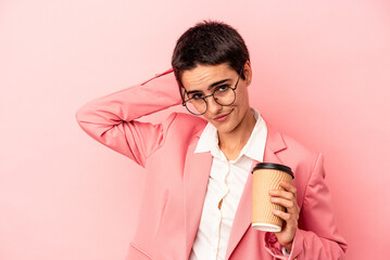 Young caucasian business woman holding a takeaway coffee isolated on pink background touching back of head, thinking and making a choice.