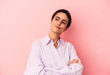 Young caucasian woman isolated on blue background dreaming of achieving goals and purposes