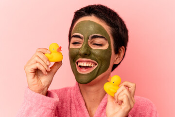 Young caucasian woman wearing a face mask isolated on pink background