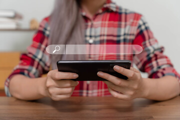 A woman's hand is searching for information via a mobile phone.