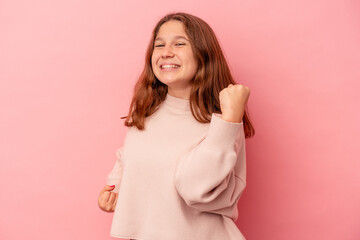 Obraz premium Little caucasian girl isolated on pink background cheering carefree and excited. Victory concept.