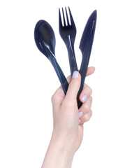 Black plastic fork, knife, spoon in hand on white background isolation