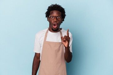Young african american store clerk isolated on blue background having an idea, inspiration concept.