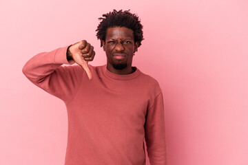 Young african american man isolated on pink background showing thumb down, disappointment concept.