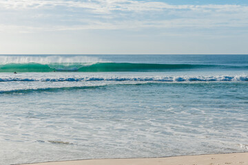 Holiday beach and blue ocean with perfect waves. Morro das Pedras beach in Florianopolis