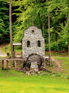 An old stone watermill in a beautiful forest.