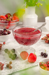 Smoothie from strawberries and fresh fruits in a bowl on a light background