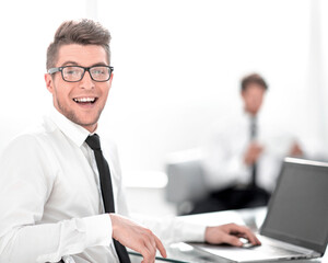 businessman sitting in office with laptop