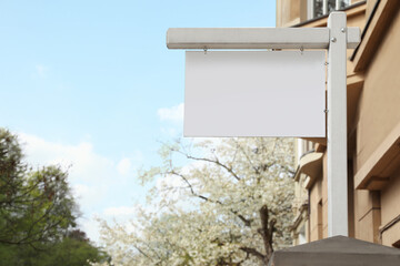 Blank advertising board on city street. Mockup for design