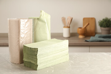 Paper towels on light grey marble table in kitchen. Space for text