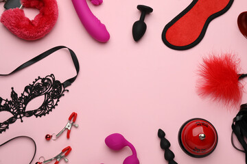 Frame of sex toys and accessories on pink background, flat lay. Space for text