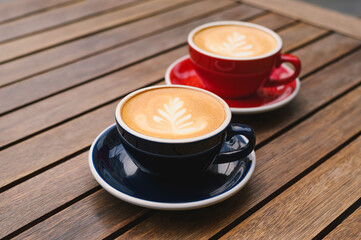 Cups of aromatic coffee on wooden table