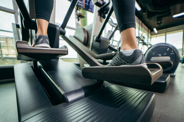 Close-up legs of fitness young woman in sports clothing  and exercising at the fitness center