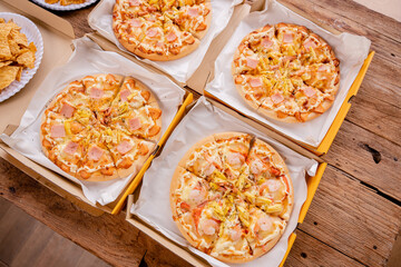 Freshly baked pizza just out of the oven on a wooden board.