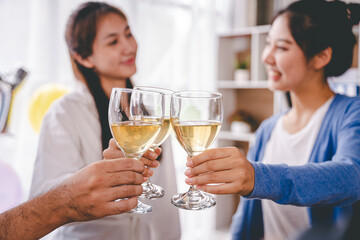 Bravo! group of young people clinking glasses Cheerful enjoying food and drink while together in the office. Focus on the glass.