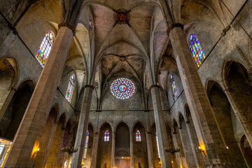 Interior view of the stained glass rose window and roof of the Basilica of Santa Maria del Mar...