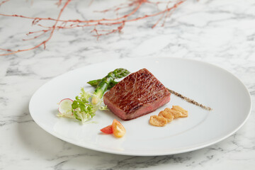 Pan fried Japanese Wagyu Beef Steak with Sea Salt served in a dish isolated on grey background