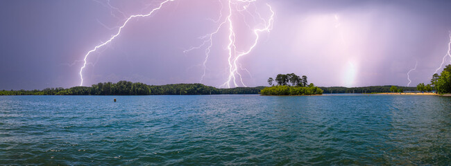 a stunning panoramic shot of the rippling blue waters of Lake Acworth with powerful storm clouds...